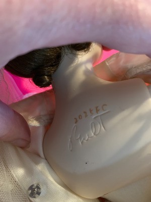 Identifying the Maker of a Porcelain Doll - lettering on the back of a doll
