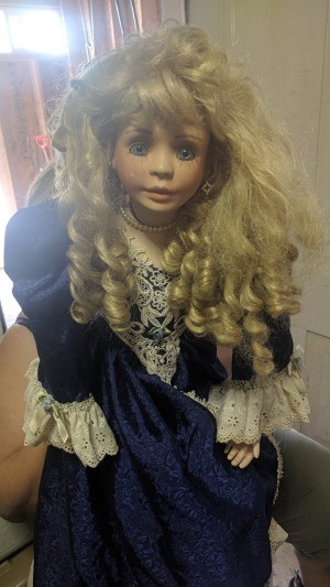 Value of a Circle of Friends Doll - large doll wearing a dark blue dress with lace at cuffs and hem