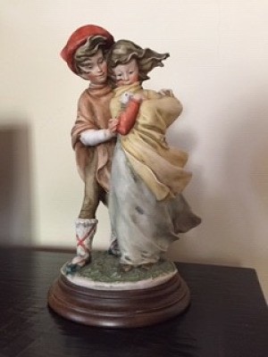 Identifying a Figurine and Its Artist - man and a woman appearing to hold a baby