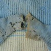 An old sweater with holey worn out arms.