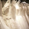 White wedding dresses hanging in a row.