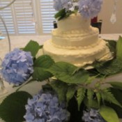 A wedding cake decorated with hydrangea blooms.