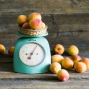 A food scale weighing apricots.