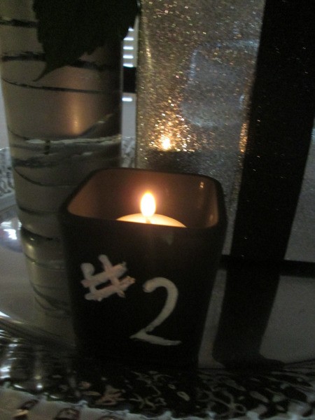 A spray painted votive with a #2 written on it.