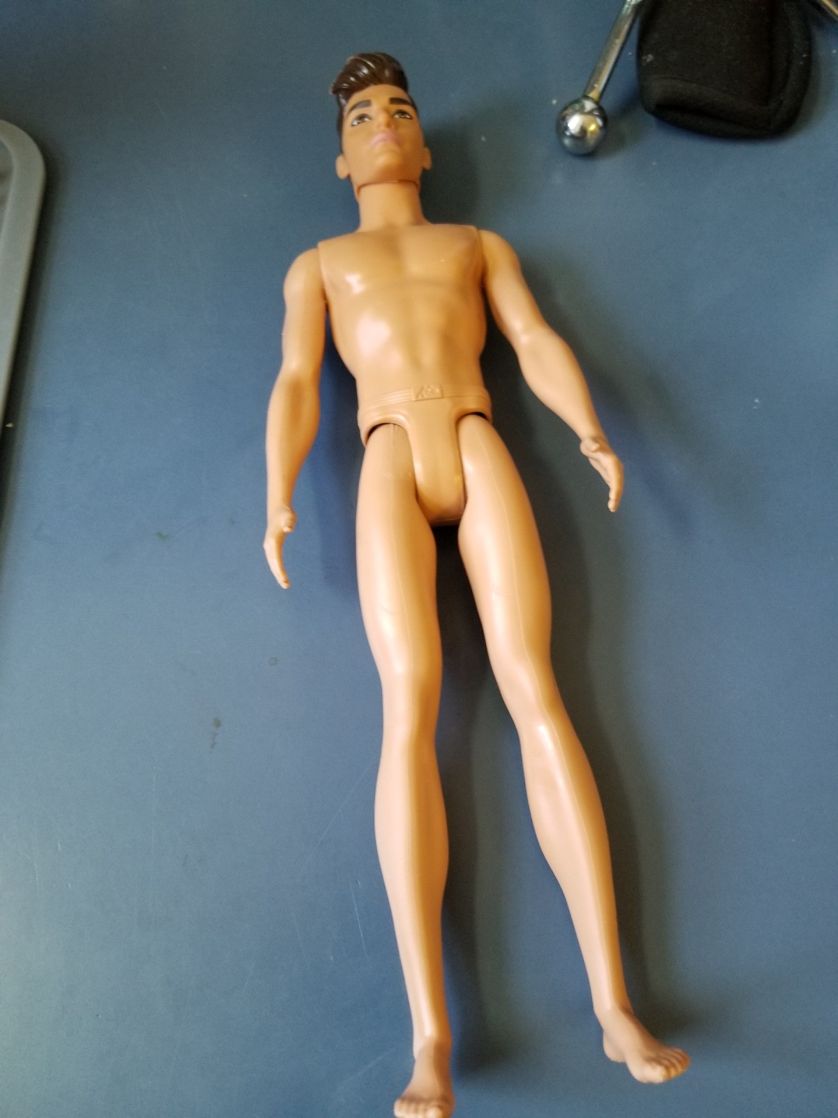 Fixing the Leg on a Ken Doll.