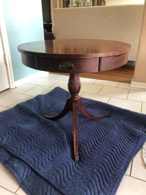 Value of a Mersman Table - round pedestal table with three brass feet and a drawer