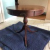 Value of a Mersman Table - round pedestal table with three brass feet and a drawer