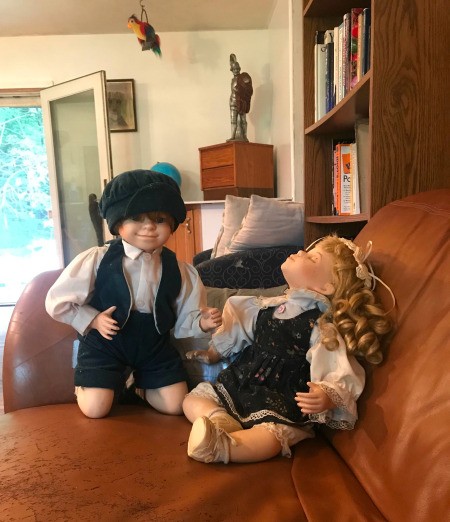 Value of Porcelain Dolls -  boy and girl doll on a couch
