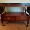 Value of an Antique Mahogany Table - wheeled table with two drawers and side fold up leaves