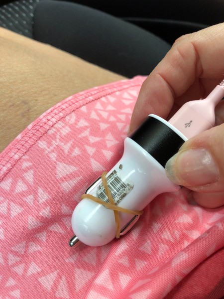 iPhone Charging LongerA car phone charger adapter with a rubber band around it.