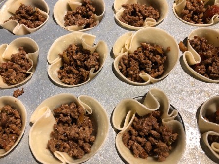 adding cooked ground beef to Taco Cups