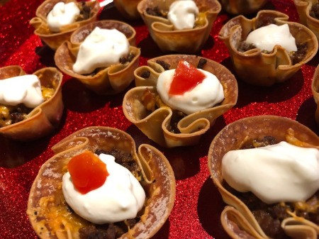 Mini Taco Cupswith sour cream & tomatoes on top