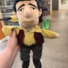 Identifying a Stuffed Toy - frowning stuffed adult male toy wearing a brown vest