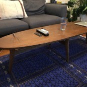 Age and Value of a Mersman Surfboard Coffee Table - table on blue rug in front of couch