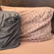 Two decorative pillows propped up on a headboard.