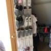 An over the door shoe organizer with shoes, socks and other accessories stored inside.