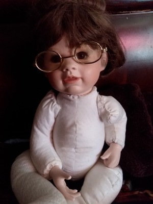 Identifying a Porcelain Doll - doll wearing wire-rim glasses