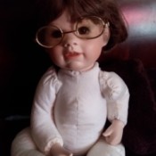Identifying a Porcelain Doll - doll wearing wire-rim glasses