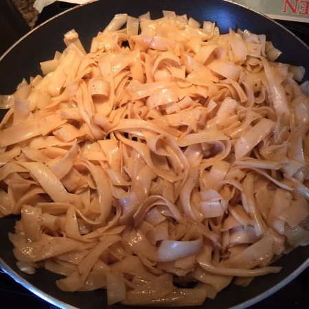 Stir Frying Flat Noodles in pan