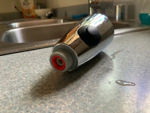 Cleaning a Kitchen Faucet Head - head removed from pipe lying on the counter