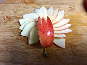 How to Make Apple Bunnies and Flowers - arrange slices as petals, top with the notched wedge, the apple stem serves as the flower stem
