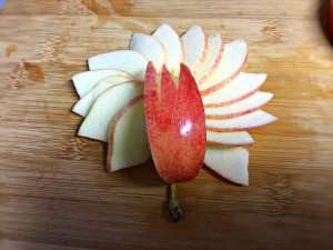 How to Make Apple Bunnies and Flowers  - arrange slices as petals, top with the notched wedge, the apple stem serves as the flower stem