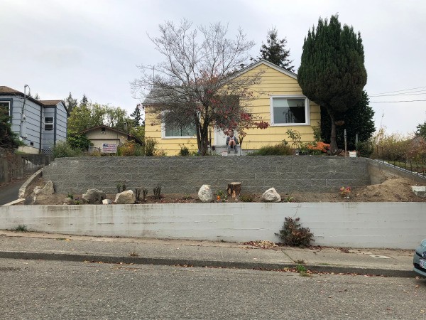 New Retaining Wall and Early Plantings - house with wall and first plantings in the fall