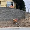 New Retaining Wall and Early Plantings - stacked wall above the original poured wall