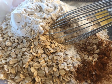 mixing oats, flour & cinnamon