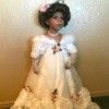 A porcelain doll with a white bridal outfit.