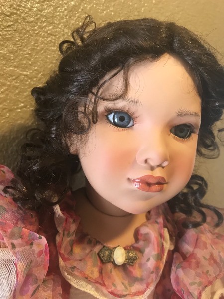 A porcelain doll with blue eyes.