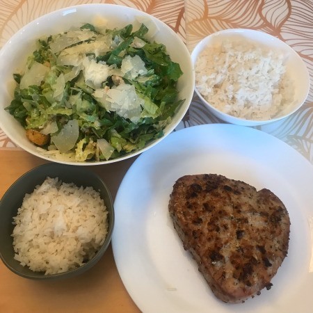 rice, salad and tuna steak on plate