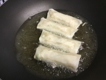 cooking Veggie Egg Rolls in oil