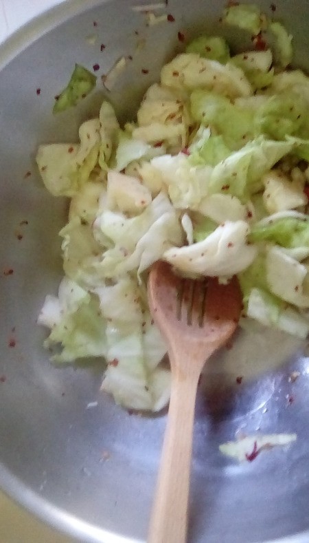 mixing spices with cabbage
