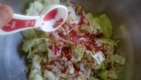 adding spices to cabbage