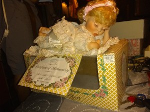 Value of a Crowne Porcelain Doll - baby doll lying on top of her box