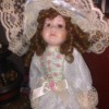 Value of an Elizabeth Gray Collection Doll - doll in white satin long dress with layers of lace and pink rosettes