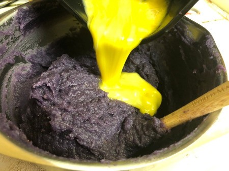 adding egg to Purple Sweet Potato Pie filling