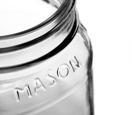 An empty mason glass jar.