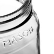 An empty mason glass jar.