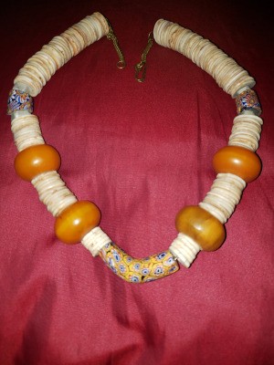 A beaded necklace with large orange beads.