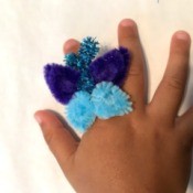 Pipe Cleaner Butterfly Ring - child's hand wearing the ring