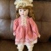 Identifying a Porcelain Doll - doll in pink dress with a lace cap