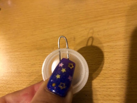 Making a Bottle Cap Glitter Pendant Necklace - poke the ends of the clip through the holes