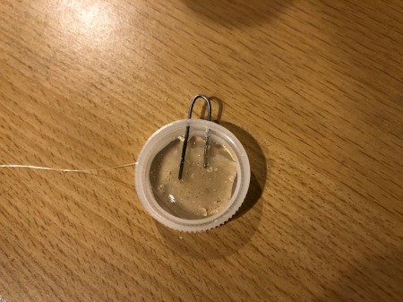 Making a Bottle Cap Glitter Pendant Necklace - fill cap 2/3 with hot glue