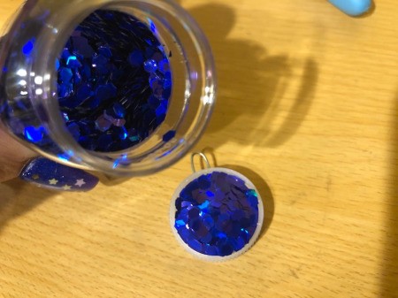 Making a Bottle Cap Glitter Pendant Necklace - quickly pour in large glitter