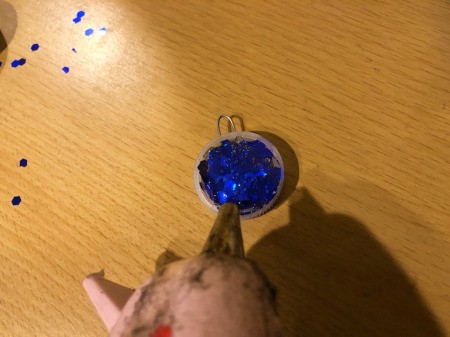 Making a Bottle Cap Glitter Pendant Necklace - add more glue on top of the glitter