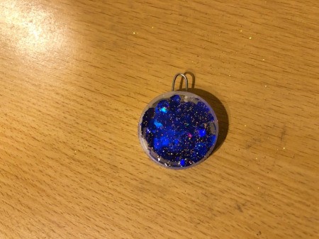 Making a Bottle Cap Glitter Pendant Necklace - quickly sprinkle in fine glitter and tap off excess