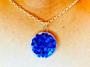 Making a Bottle Cap Glitter Pendant Necklace - finished pendant being worn