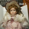 Identifying Porcelain Dolls  - curly haired doll wearing a pink dress with white lace